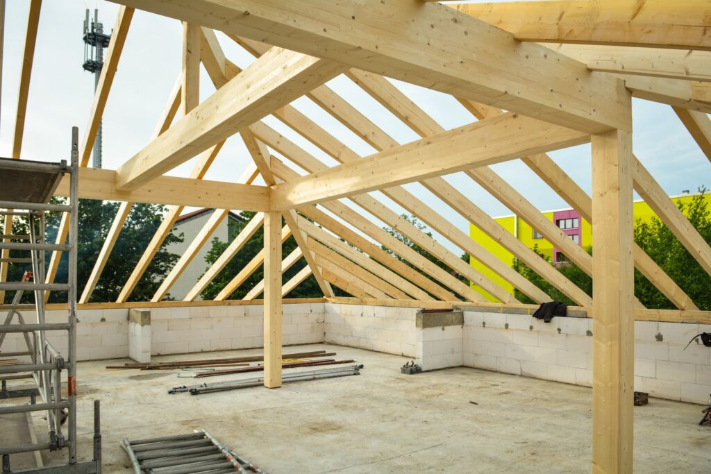 Roof framing tie-in for a new home addition under an open sky