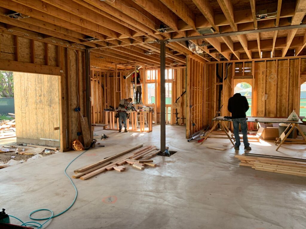 Construction crew building a home addition framework with interior carpentry work