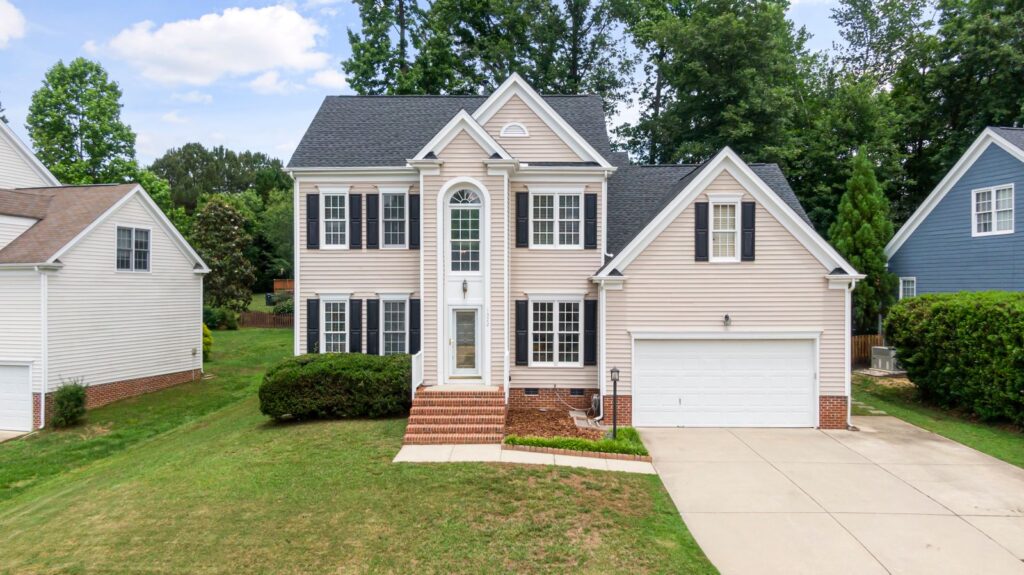 Two-story suburban residence with new siding and a well-maintained lawn