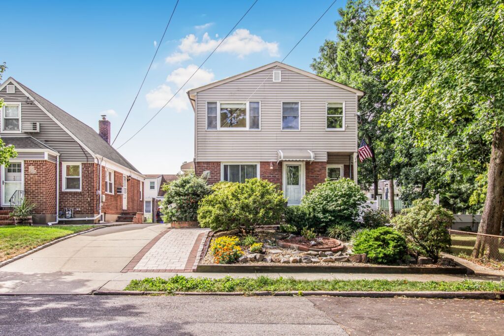 Two-story Westchester NY home with new siding and a landscaped garden